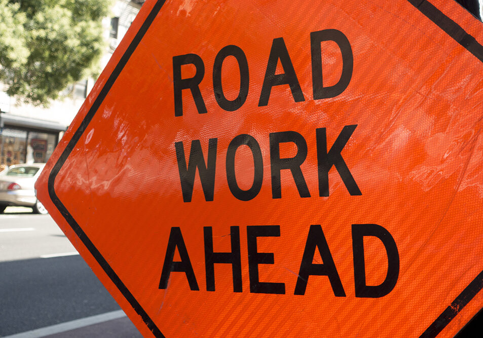 diamond shaped orange red reflector street sign that reads road diamond shaped orange red reflector street sign that reads road